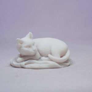 The statue of a cat sleeping on a pillow in White color