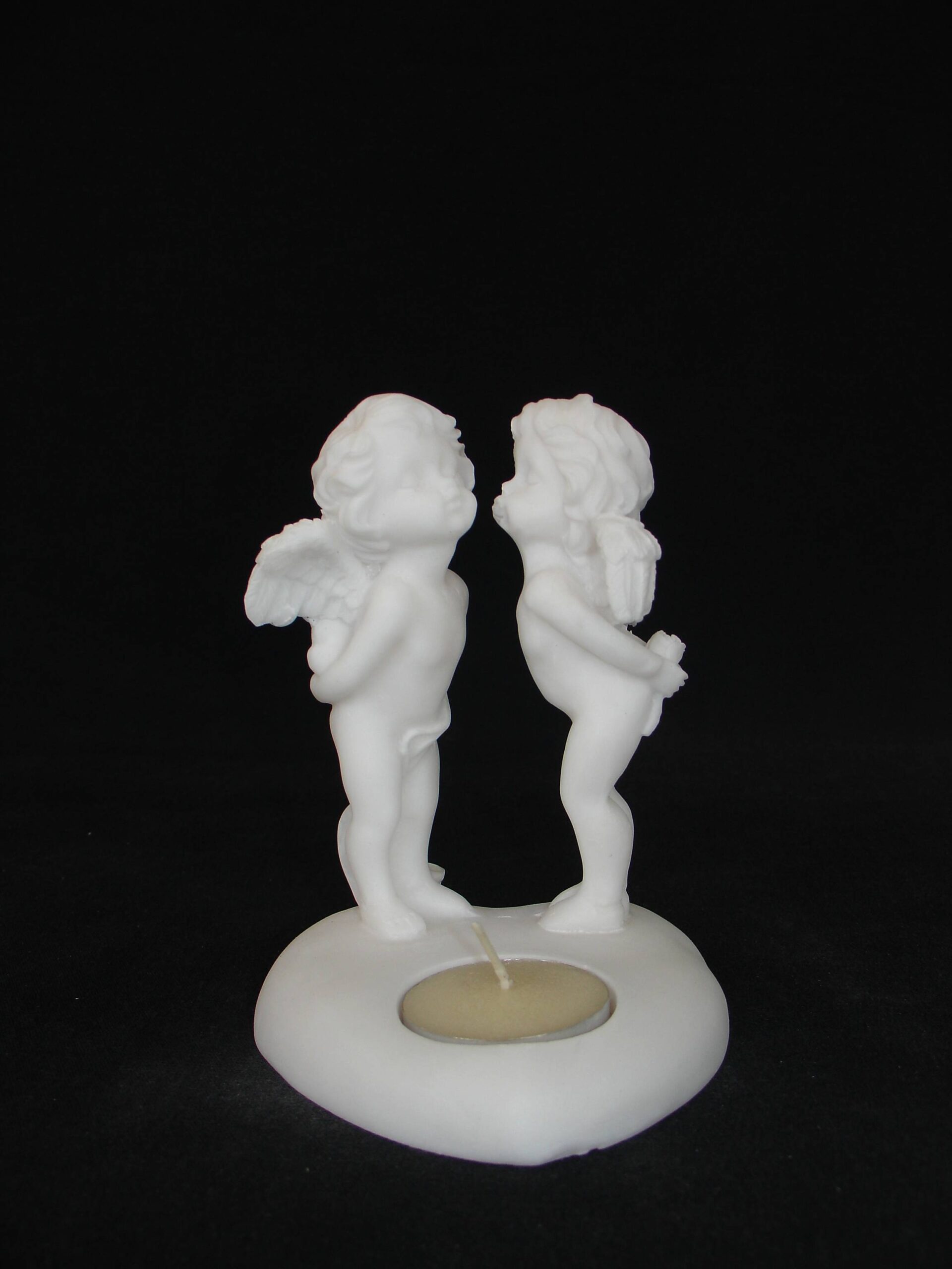 3-642-w-front A statue of two Angels standing on a heart shape candle type 3 in White color