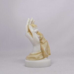 The statue of a boy is held by a hand in Patina color