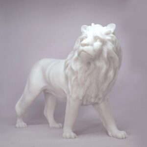 The statue of a male Lion looking high in White color