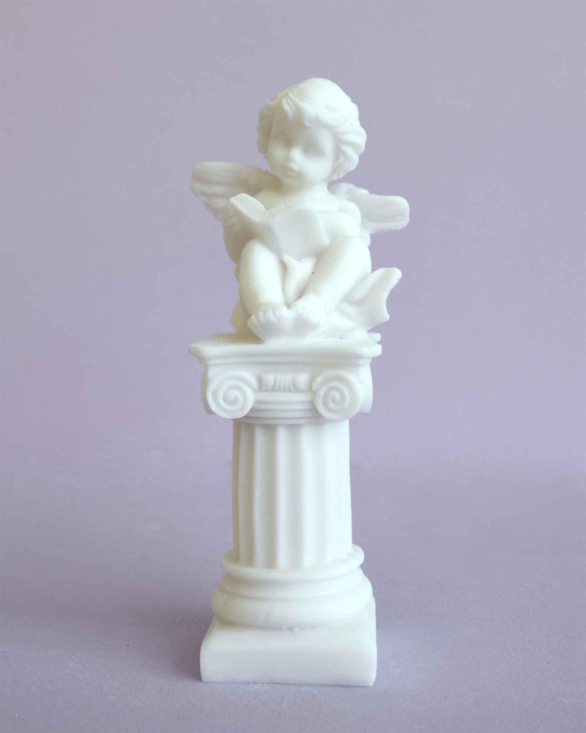 629-A1 A statue of an Angel sitting on a column in White color