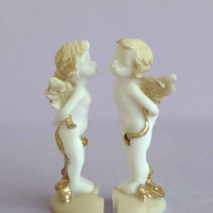 The statue of two Angels standing on a broken heart in Patina color