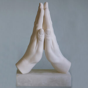 The statue of two hands in prayer position in White color